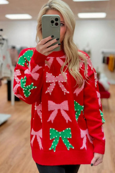 fiery red women's christmas sweater with bow and pearl detail elegant festive holiday style for a flattering fit made for easy styling and wardrobe