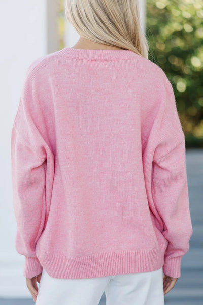 Cozy Women's Pink Baggy Graphic Sweater with Love Script - Effortless Casual Chic for Everyday Style made for easy styling and wardrobe coordination,