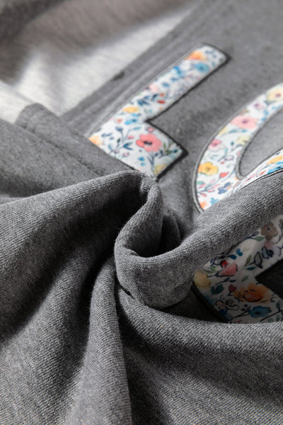 Trendy Women's Dark Grey LOVE Graphic Sweatshirt with Exposed Seams & Stylish Asymmetrical Hem for Effortless Chic Look