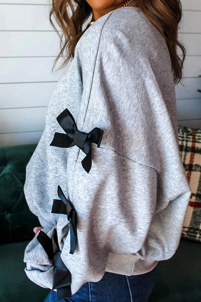 Festive Women's Merry Christmas Graphic Sweatshirt with Ribbon Bow, Split Sleeves, and Relaxed Fit for Holiday Cheer