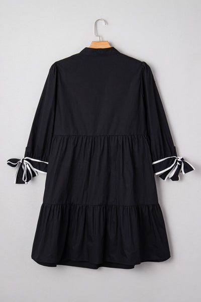 Chic Plus Size Women's Black V-Neck Mini Dress with Contrast Trim and Knot Cuffs for Effortless Style