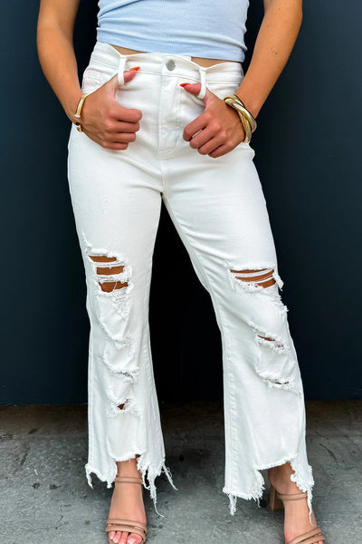 Trendy Women's White Distressed Cowgirl Jeans with Asymmetric Cut and Raw Hem  Perfect for Casual Chic Outfits