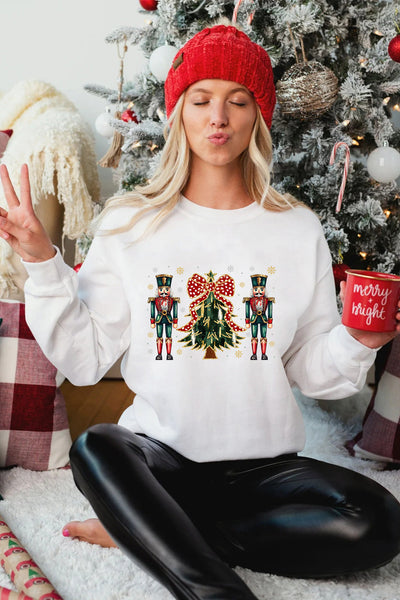 Women's Nutcracker and Christmas Tree Graphic Pullover in Winter White with practical styling and dependable silhouette control.