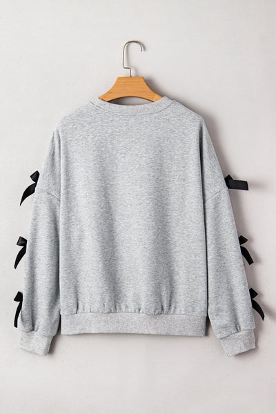 Festive Women's Merry Christmas Graphic Sweatshirt with Ribbon Bow, Split Sleeves, and Relaxed Fit for Holiday Cheer