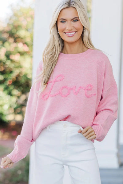 Cozy Women's Pink Baggy Graphic Sweater with Love Script - Effortless Casual Chic for Everyday Style made for easy styling and wardrobe coordination,