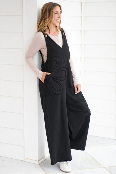 Chic Women's Black Loose-Fit Jumpsuit with Floral Patch & Raw Hem for Effortless Casual Style
