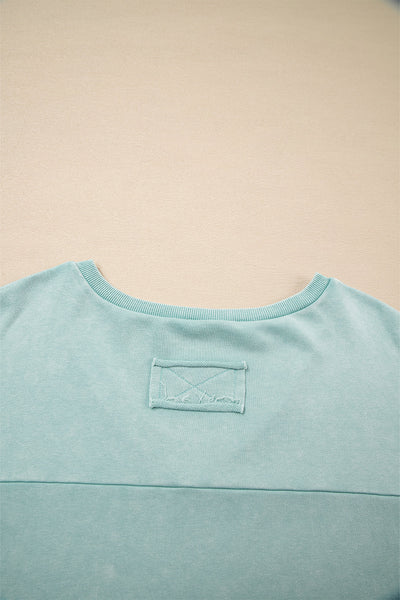 Effortless Women's Mist Blue V-Neck Pullover Top with Exposed Seams & Button Detail for Chic Casual Style