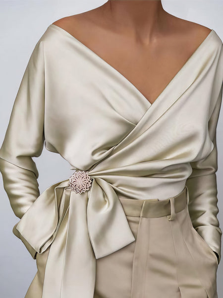 women's lustrous satin wrap blouse with brooch detail made for easy styling and wardrobe coordination, with premium-like structure and finish. with