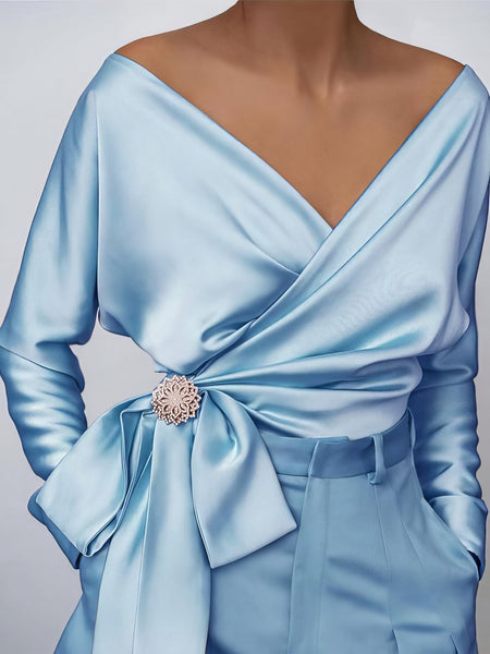 women's lustrous satin wrap blouse with brooch detail made for easy styling and wardrobe coordination, with premium-like structure and finish. with