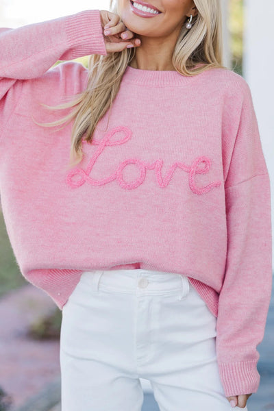 Cozy Women's Pink Baggy Graphic Sweater with Love Script - Effortless Casual Chic for Everyday Style made for easy styling and wardrobe coordination,