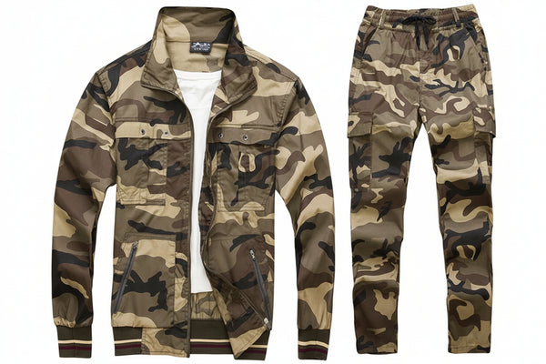 A two-piece camouflage tracksuit set consisting of a zip-up jacket and matching pants, laid flat on a gray textured background. The jacket is styled open over a white t-shirt, and the pants are shown flat to the right.